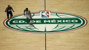 FILE - In this Jan. 14,2017, file photo, San Antonio Spurs Kawhi Leonard dribbles the ball past the middle of the court as Phoenix Suns P.J. Tucker follows in the second half of their regular-season NBA basketball game in Mexico City. An NFL team in London? An NBA franchise in Mexico City? We're drawing closer to the day when a team from those leagues puts down roots outside the United States and Canada. (AP Photo/Rebecca Blackwell, File)