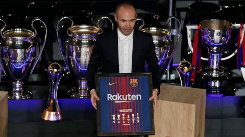 FC Barcelona's Andres Iniesta poses with a FC Barcelona's t-shirt during a farewell event at the Camp Nou stadium in Barcelona, Spain, Friday, May 18, 2018. Iniesta announced last month he would leave Barcelona after 16 seasons. His last match for Barcelona is on Sunday against Real Sociedad at Camp Nou. (AP Photo/Manu Fernandez)