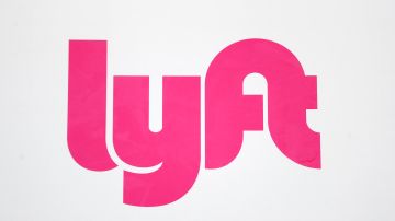 A Lyft sign is shown at a shared ride pickup location for automobiles Tuesday, March 24, 2020 jn Detroit. (AP Photo/Paul Sancya)