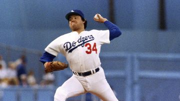 FILE - Los Angeles Dodgers pitcher Fernando Valenzuela prepares to release the ball in the first inning of the opening game of the National League Championship series against the St. Louis Cardinals, Oct. 9, 1985, in Los Angeles. The Dodgers will retire the No. 34 jersey of Valenzuela during a three-day celebration this summer. (AP Photo/Lennox McLendon, File)