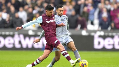 West Ham's Edson Alvarez challenges for the ball with Everton's Dwight McNeil during the English Premier League soccer match between West Ham United and Everton at the London stadium in London, Sunday, Oct. 29, 2023. (AP Photo/Kirsty Wigglesworth)