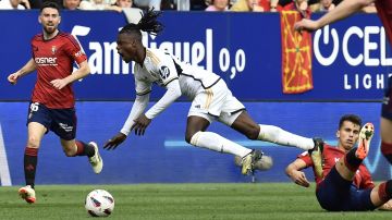 Real Madrid's David Alaba is fouled by Osasuna's Lucas Torrom during the Spanish La Liga soccer match between Osasuna and Real Madrid at the El Sadar stadium in Pamplona, Spain, Saturday, March 16, 2023. (AP Photo/Alvaro Barrientos)