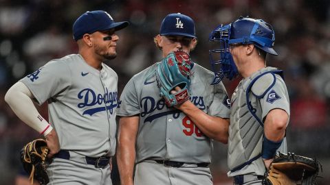 Los Angeles Dodgers pitcher Landon Knack (96) speaks with catcher Will Smith, right, and shortstop Miguel Rojas (11) on the mound in the second inning of a baseball game against the Atlanta Braves, Friday, Sept. 13, 2024, in Atlanta. (AP Photo/Mike Stewart)