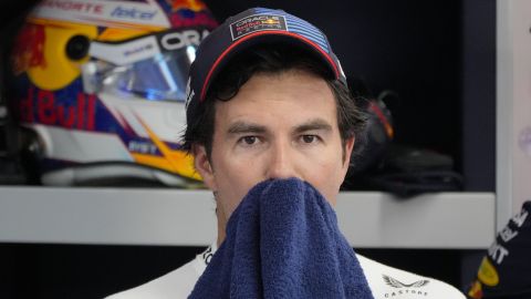 Red Bull driver Sergio Perez of Mexico wipes his sweat inside their garage during the second practice session of the Singapore Formula One Grand Prix at the Marina Bay Street Circuit, in Singapore, Friday, Sept. 20, 2024. (AP Photo/Vincent Thian)