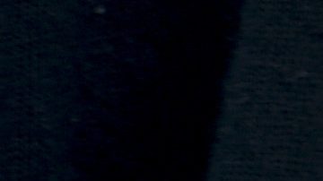 A Boca Juniors fan wears a T-shirt featuring the late soccer star Diego Maradona smoking a cigar and donning a red star beret, during an Argentine soccer league match against River Plate at La Bombonera stadium in Buenos Aires, Argentina, Saturday, Sept. 21, 2024.(AP Photo/Gustavo Garello)