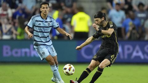 Los Angeles FC midfielder Ilie Sanchez (6) kicks the ball away from Sporting Kansas City attacker Dániel Sallói (10) during the second half of an MLS soccer match Saturday, Oct. 5, 2024, in Kansas City, Kan. Los Angeles FC won 3-0. (AP Photo/Charlie Riedel)