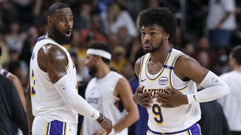 Bronny James (9), derecha, de los Lakers de Los Ángeles, entra a la cancha con su padre LeBron James (23), durante la primera mitad de un partido de pretemporada de baloncesto de la NBA el domingo 6 de octubre de 2024, en Palm Desert, California (Foto AP/William Liang)