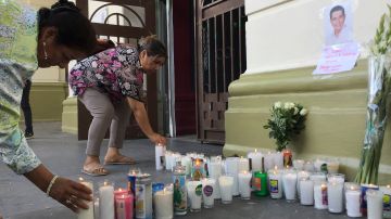 Supporters of slain Mayor Alejandro Arcos place candles and flowers at the entrance of the municipal building one week after he took office in Chilpancingo, Mexico, Monday, Oct. 7, 2024. (AP Photo/Alejandrino Gonzalez)