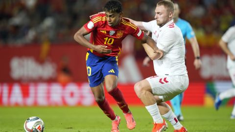 Spain's Lamine Yamal, left, is challenged by Denmark's Victor Nelsson during the UEFA Nations League group 4 soccer match between Spain and Denmark in Murcia, Spain, Saturday, Oct. 12, 2024. (AP Photo/Jose Breton)