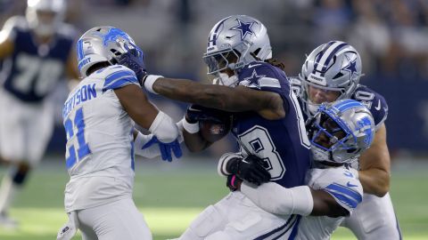 Dallas Cowboys wide receiver CeeDee Lamb, center, is tackled after catching a pass by Detroit Lions' Amik Robertson (21) and others in the second half of an NFL football game in Arlington, Texas, Sunday, Oct. 13, 2024. (AP Photo/Gareth Patterson)