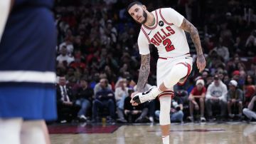 Chicago Bulls guard Lonzo Ball stretches his foot during the second half of an NBA preseason basketball game against the Minnesota Timberwolves in Chicago, Wednesday, Oct. 16, 2024. The Bulls won 125-123.(AP Photo/Nam Y. Huh)