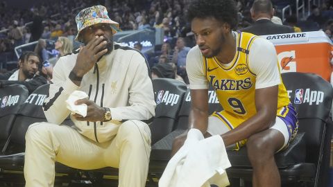 Los Angeles Lakers forward LeBron James, left, talks with guard Bronny James (9) during an NBA preseason basketball game against the Golden State Warriors in San Francisco, Friday, Oct. 18, 2024. (AP Photo/Jeff Chiu)