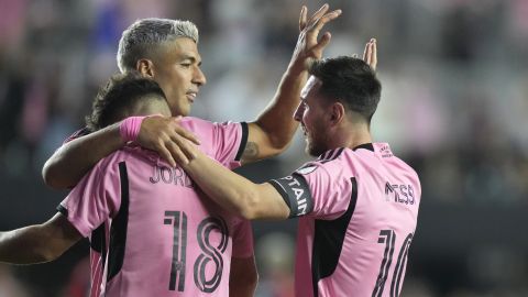 Inter Miami forward Lionel Messi (10) celebrates with Luis Suarez, center, and Jordi Alba (18) after scoring a goal during the second half of an MLS soccer match against the New England Revolution, Saturday, Oct. 19, 2024, in Fort Lauderdale, Fla. (AP Photo/Lynne Sladky)