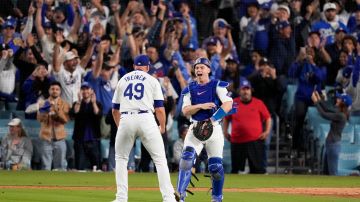 Los Angeles Dodgers pitcher Blake Treinen and catcher Will Smith celebrate their win against the New York Mets in Game 6 of a baseball NL Championship Series, Sunday, Oct. 20, 2024, in Los Angeles. The Dodgers will face the New York Yankees in the World Series. (AP Photo/Mark J. Terrill)