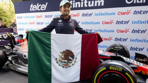 Red Bull driver Sergio Perez, from Mexico, holds his national flag during a press conference in Mexico City, Wednesday, Oct. 23, 2024, ahead of the Formula One Mexico Grand Prix auto race next weekend. (AP Photo/Moises Castillo)