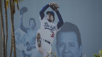 A mural is displayed of Los Angeles Dodgers legend Fernando Valenzuela at Dodger Stadium Thursday, Oct. 24, 2024, in Los Angeles. Valenzuela died Tuesday at age 63. The New York Yankees face the Dodgers in Game 1 of the baseball World Series Friday. (AP Photo/Julio Cortez)