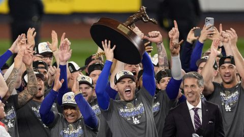 Los Angeles Dodgers' Freddie Freeman holds up the MVP trophy after the Dodgers beat the New York Yankees in Game 5 to win the baseball World Series, Thursday, Oct. 31, 2024, in New York. (AP Photo/Seth Wenig)