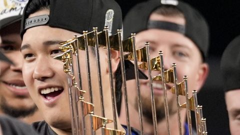 Los Angeles Dodgers' Shohei Ohtani celebrates with the trophy after their win against the New York Yankees in Game 5 to win the baseball World Series, Thursday, Oct. 31, 2024, in New York. (AP Photo/Ashley Landis)