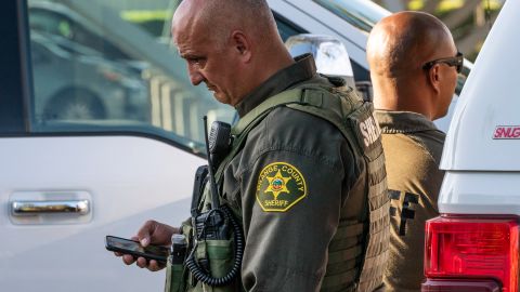 Orange County Sheriff deputies guard the Geneva Presbyterian Church in Laguna Woods, Calif., Sunday, May 15, 2022, after a fatal shooting. (AP Photo/Damian Dovarganes)