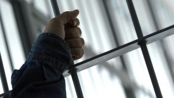 A man, detained for illegal border crossing, holds a bar in the detention center of the Hungarian Border Guard in Nyirbator, Hungary, near the Ukrainian border (260 km east of Budapest) April 12, 2007. ungary is prepared to reinforce its non-EU borders and will join the Schengen Agreement and its Information System (SIS), a central database, at the beginning of 2008. The Schengen system is an agreement among European states which allows the abolition of systematic border controls between the participating countries while they guard the external borders heavily. (AP Photo/Bela Szandelszky)