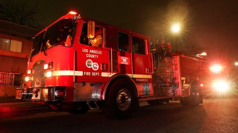 Los Angeles County Fire Department vehicles sit at a medical call Friday, Jan. 7, 2022, in Inglewood, Calif. Occasionally, firefighters transport patients to the hospital in fire engines because of short staffing amid an explosion in omicron-fueled coronavirus infections at an ambulance company that the fire department contracts with. (AP Photo/Mark J. Terrill)