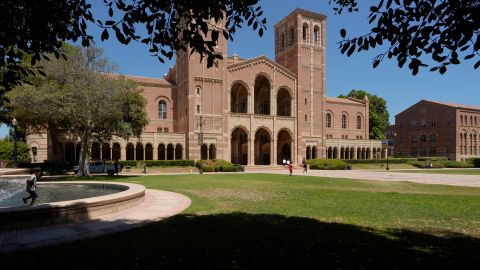 Children play outside Royce Hall at the University of California, Los Angeles, campus in Los Angeles, Thursday, Aug. 15, 2024. (AP Photo/Damian Dovarganes)