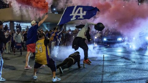 Fans celebrate on the streets after the Los Angeles Dodgers won against the New York Yankees in the baseball World Series Wednesday, Oct. 30, 2024, in Los Angeles. (AP Photo/Damian Dovarganes)