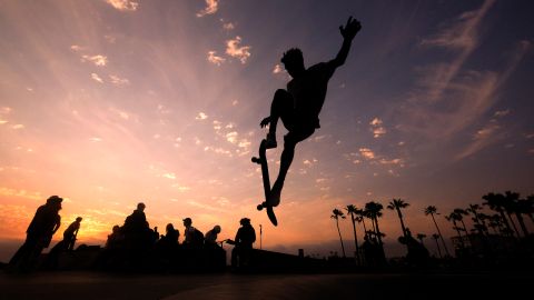 FILE - In this Wednesday, June 16, 2021, file photo, a skateboarder is silhouetted as he jumps high at the skateboard park during sunset in the Venice Beach section of Los Angeles. The Southwest U.S. continued to bake Saturday, June 19, and weather forecasters kept warnings in effect for excessive heat in Arizona, Nevada and desert areas, at least through the weekend. (AP Photo/Ringo H.W. Chiu, File)