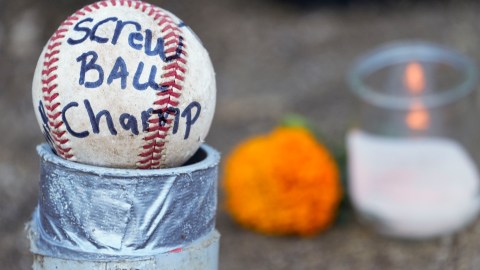 Candles and baseballs are placed outside Dodger Stadium after the death of former Dodgers pitcher Fernando Valenzuela, Wednesday, Oct. 23, 2024, in Los Angeles. (AP Photo/Damian Dovarganes)