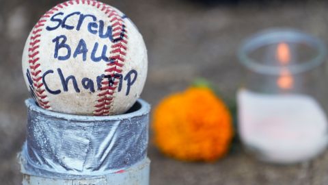 Candles and baseballs are placed outside Dodger Stadium after the death of former Dodgers pitcher Fernando Valenzuela, Wednesday, Oct. 23, 2024, in Los Angeles. (AP Photo/Damian Dovarganes)