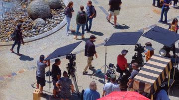 Production crew, extras, and camera operators get ready to film an episode of NCIS:Los Angeles on location in Los Angeles on Monday May, 1, 2017. (AP Photo/Richard Vogel)