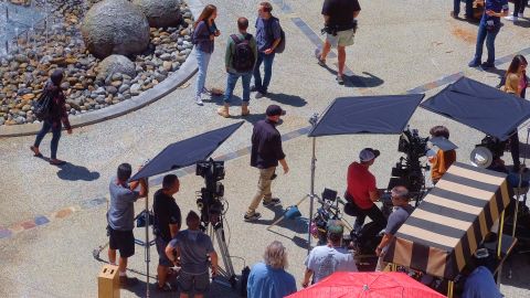 Production crew, extras, and camera operators get ready to film an episode of NCIS:Los Angeles on location in Los Angeles on Monday May, 1, 2017. (AP Photo/Richard Vogel)