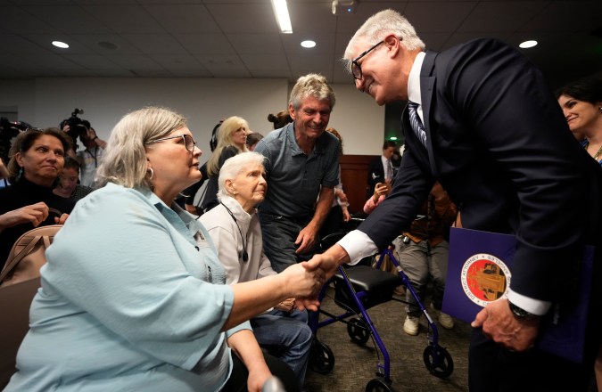 Los Angeles County District Attorney George Gascon, right, shakes hands with members of the Menendez family after addressing the case of brothers Erik and Lyle Menendez at a news conference at the Hall of Justice in Los Angeles, Thursday, Oct. 24, 2024, in Los Angeles. (AP Photo/Damian Dovarganes)
