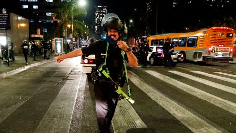 A police office directs people to leave the streets during a protest in Los Angeles, Wednesday, Nov. 4, 2020, following Tuesday's election. (AP Photo/Ringo H.W. Chiu)