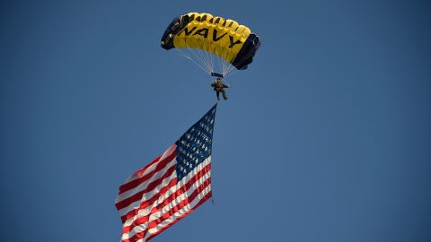 A U.S. Navy parachutist carries an American flag before the Holiday Bowl NCAA college football game between Minnesota and Washington State Tuesday, Dec. 27, 2016, in San Diego. (AP Photo/Denis Poroy)