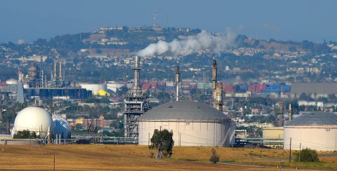 FILE - This July 16, 2014 file photo shows the Phillips 66 refinery in the Wilmington area of Los Angeles. The Commerce Department reports on the U.S. trade deficit in July. The report will be released Thursday, Sept. 4, 2014. The nation's trade balance in oil has continued to improve this year. The U.S. had a petroleum trade deficit of $105.3 billion in the first half of this year, down from $125.7 billion last year. (AP Photo/Mark J. Terrill)