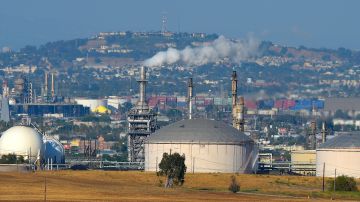 FILE - This July 16, 2014 file photo shows the Phillips 66 refinery in the Wilmington area of Los Angeles. The Commerce Department reports on the U.S. trade deficit in July. The report will be released Thursday, Sept. 4, 2014. The nation's trade balance in oil has continued to improve this year. The U.S. had a petroleum trade deficit of $105.3 billion in the first half of this year, down from $125.7 billion last year. (AP Photo/Mark J. Terrill)