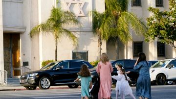 Mothers and daughters walk across the Congregation Shaarei Tefila synagogue in Los Angeles on Saturday, Oct. 7, 2023. (AP Photo/Damian Dovarganes)