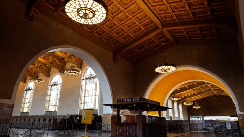 The interior of Union Station in Los Angeles appears on March 23, 2021. The Oscars are headed to the historic site for the first time this year. With wide open spaces and 65-foot high ceilings, it’s ideal for a big crew and cameras. It’s been used in car commercials, reality shows and procedurals. But its beamed ceilings, Spanish tile floors and regal bronze chandeliers really shine in cinema where it’s played train stations, banks, police stations, clubs and airports. (AP Photo/Chris Pizzello)