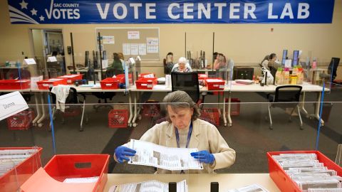 FILE - Election worker Donna Young inspects a mail-in ballot for damage at the Sacramento County Registrar of Voters in Sacramento, Calif., June 3, 2022. (AP Photo/Rich Pedroncelli, File)