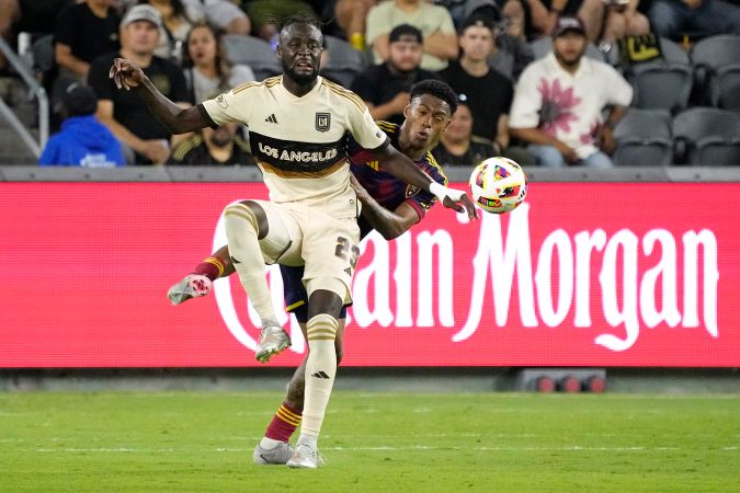 Los Angeles FC forward Kei Kamara, left, and Real Salt Lake midfielder Nelson Palacio battle for the ball during the second half of an MLS soccer match Wednesday, July 17, 2024, in Los Angeles. (AP Photo/Mark J. Terrill)