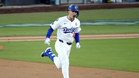 Los Angeles Dodgers' Tommy Edman celebrates after hitting a home run against the New York Yankees during the second inning in Game 2 of the baseball World Series, Saturday, Oct. 26, 2024, in Los Angeles. (AP Photo/Julio Cortez)