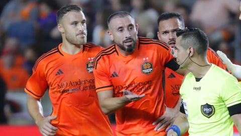 Houston Dynamo defender Erik Sviatchenko, left, midfielder Hector Herrera, center, and midfielder Artur, back right, appeal to referee Armando Villarreal, front right, after Herrera received a red card for fouling Seattle Sounders defender Jackson Ragen during the second half of Game 2 in the first round of the MLS Cup soccer playoffs Sunday, Nov. 3, 2024, in Houston. (AP Photo/Michael Wyke)