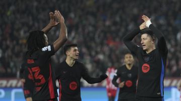 Barcelona's Robert Lewandowski, right, celebrates after scoring during the Champions League opening phase soccer match between Red Star and Barcelona at the Rajko Mitic Stadium in Belgrade, Serbia, Wednesday, Nov. 6, 2024. (AP Photo/Darko Vojinovic)