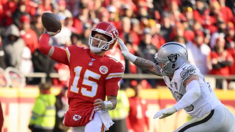 Kansas City Chiefs quarterback Patrick Mahomes (15) is chased by Las Vegas Raiders defensive end Maxx Crosby (98) during the first half of an NFL football game, Friday, Nov. 29, 2024 in Kansas City, Mo. (AP Photo/Reed Hoffmann)