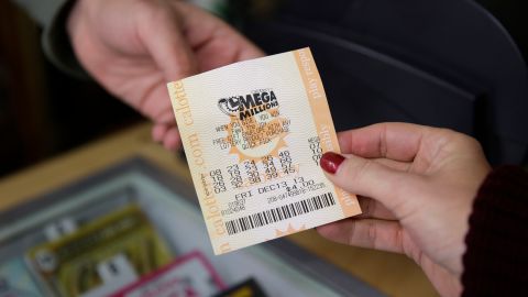 A woman purchases a Mega Millions lottery ticket at a Financial District liquor store Thursday, Dec. 12, 2013, in San Francisco. Lottery officials behind Mega Millions say the lesser known game alongside Powerball is grabbing some attention with an estimated $400 million jackpot, an estimated amount that comes less than two months after a major revamp to the game. The estimated jackpot is the fifth largest ever and second largest in Mega Millions history, trailing behind the $656 million Mega Millions jackpot in 2012. (AP Photo/Eric Risberg)