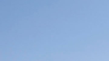 Morban Zarate, a response manager for Douple Barrel Environmental services walks around a truck blown over by strong winds Wednesday Feb. 2, 2011 near Rancho Cucamonga, Calif. The National Weather Service says winds gusts of up to 80 mph could blow through some areas in southern California, including the Cajon Pass, a heavily-traveled truck route through the mountains east of Los Angeles.(AP Photo/Nick Ut)