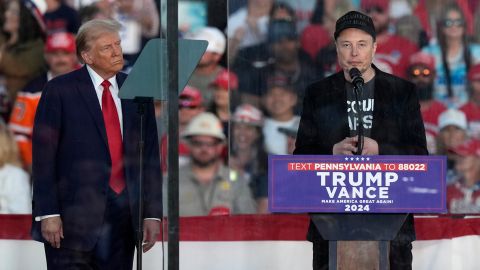 Republican presidential nominee former President Donald Trump listens as Elon Musk speaks during a campaign rally at the Butler Farm Show, Saturday, Oct. 5, 2024, in Butler, Pa. (AP Photo/Julia Demaree Nikhinson, File)