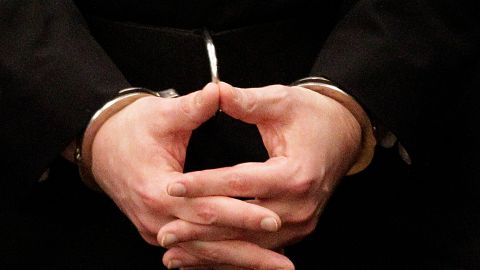 Mass murderer Anders Behring Breivik, hands are seen in handcuffs as he arrives at the court room in a courthouse in Oslo Friday Aug. 24, 2012 . Breivik was convicted Friday of terrorism and premeditated murder for bomb and gun attacks that killed 77 people and sentenced to a special prison term that would allow authorities to keep him locked up for as long as he is considered dangerous. (AP Photo/Frank Augstein)