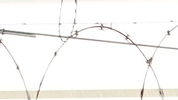 FILE - A man stands near tents on a sidewalk in San Francisco, Nov. 21, 2020. A one-night count found San Francisco's homeless population dipped slightly to roughly 7,800 people in 2022. The last point-in-time count found more than 8,000 residents in 2019 in a city where unhoused people are highly visible. (AP Photo/Jeff Chiu, File)